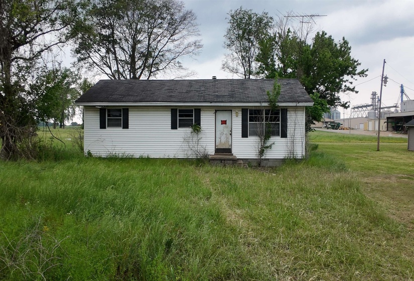 Single-story structure with white siding and a dark shingle roof