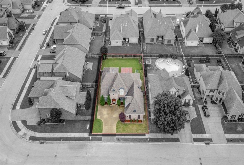 Aerial perspective showcasing a residential property with a green lawn