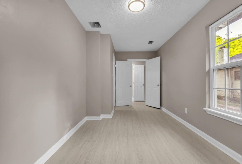 Neutral wall color with white trim and wood-finish flooring