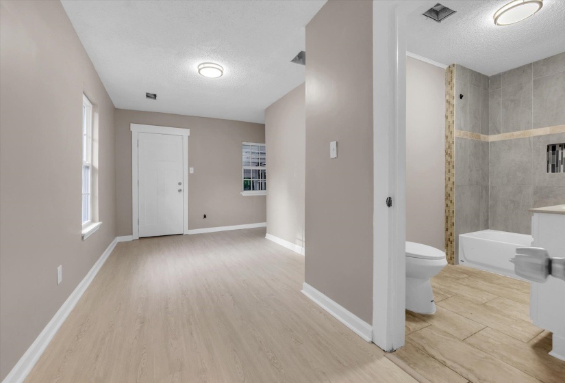 Spacious interior with wood-finish flooring and neutral wall tones