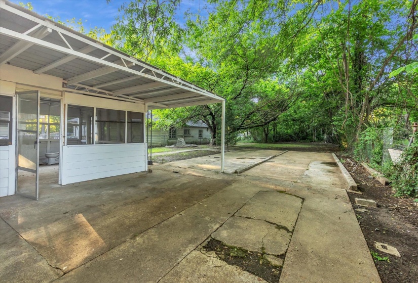 Covered carport structure with an attached screened porch