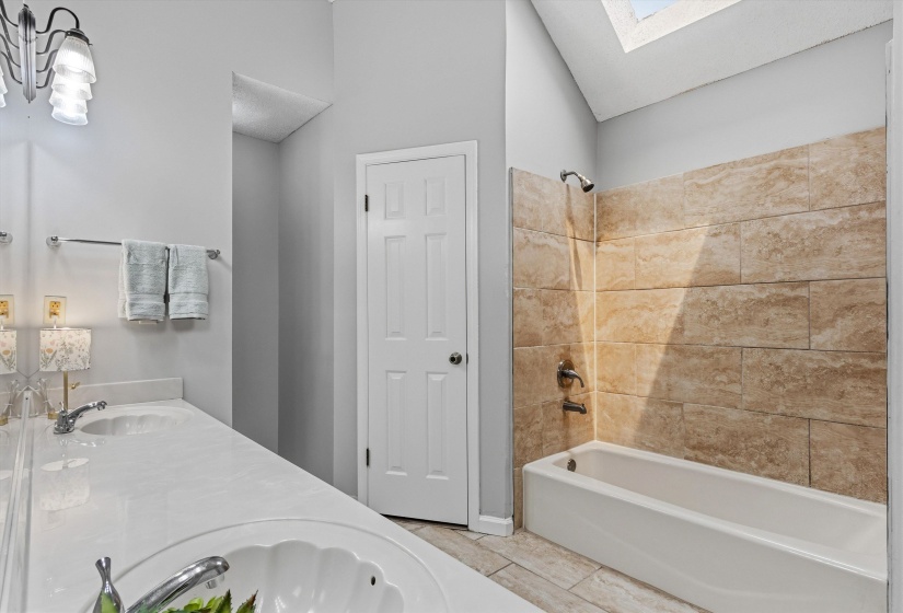 Bathroom with dual vanity featuring integrated sinks and chrome fixtures