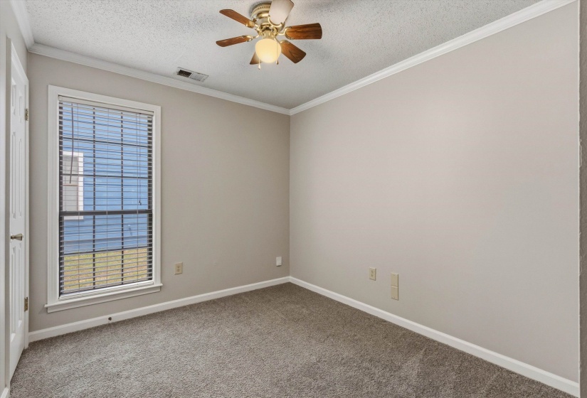 Room featuring a single window with blinds, neutral wall paint, and gray carpet flooring