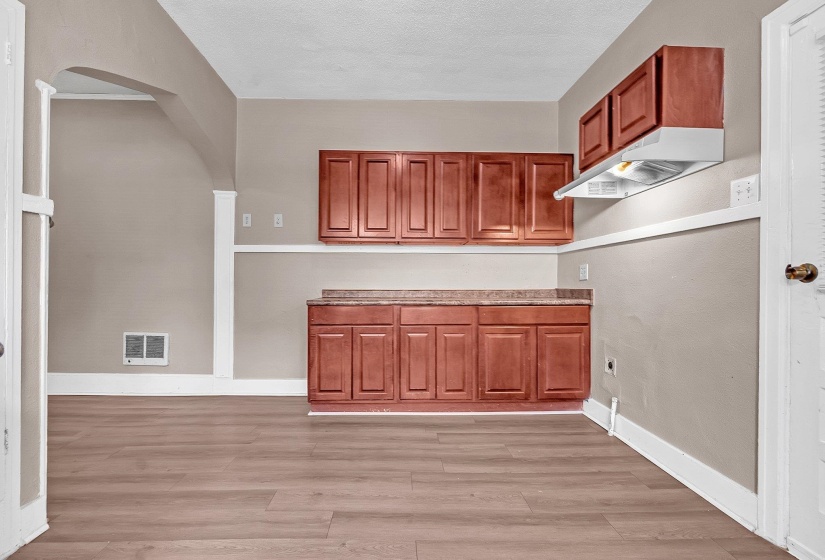 Wood-finish flooring throughout, complemented by a light neutral wall color