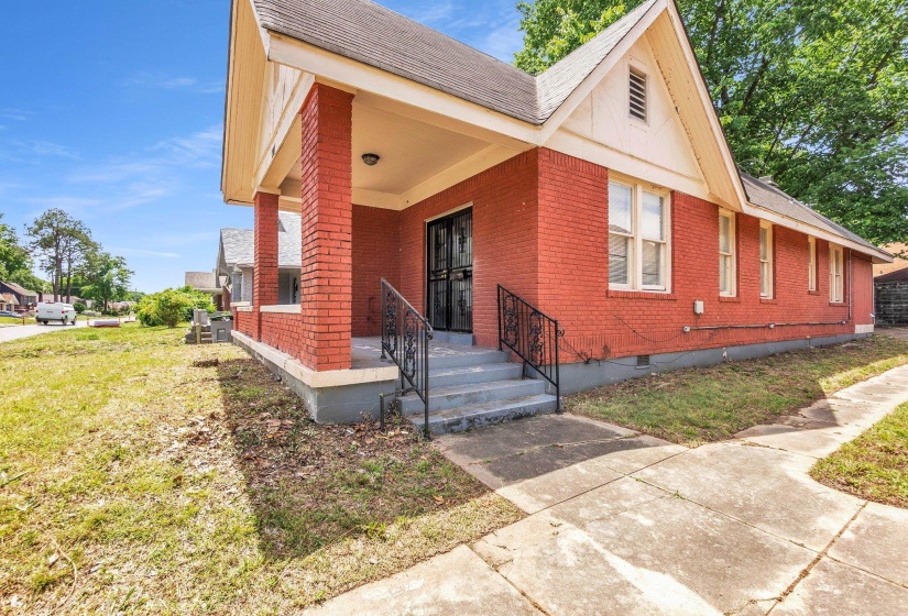 Brick exterior with a covered porch and concrete steps