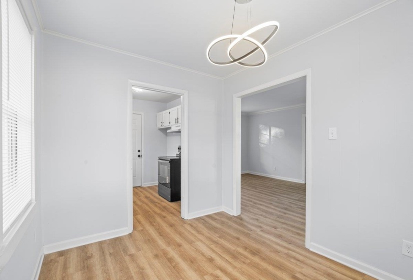 Light wood-finish flooring complements the neutral wall color