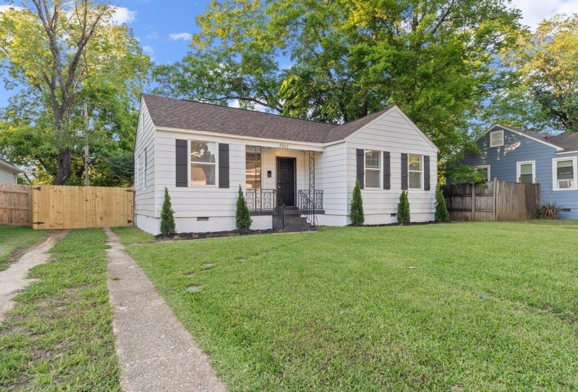 White siding exterior with a dark shingle roof and black shutters