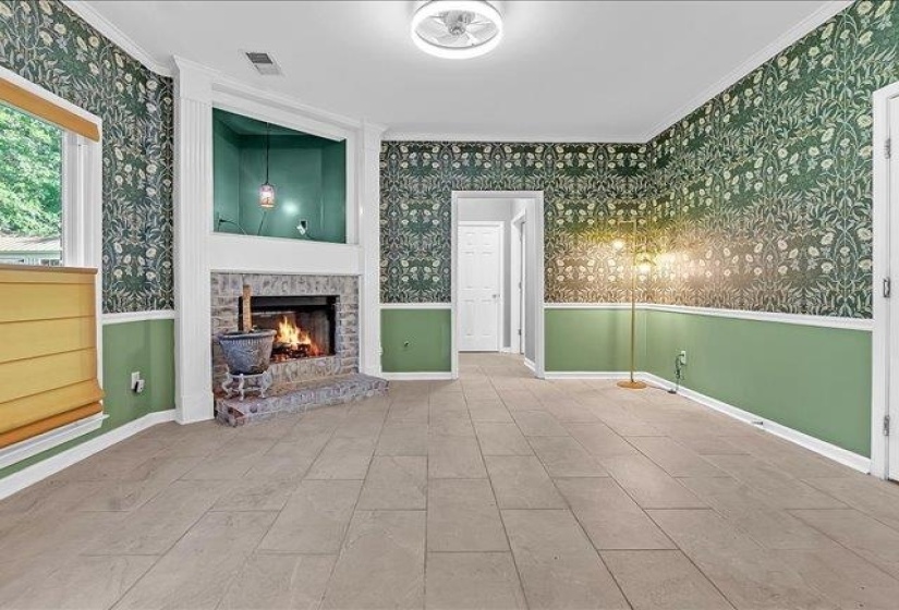 Corner stone fireplace with a raised hearth, featuring a mantel with built-in lighting