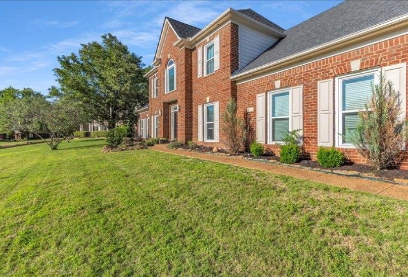 Traditional brick exterior featuring white shutters