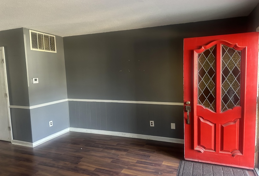 Vibrant red entry door with decorative glass panels