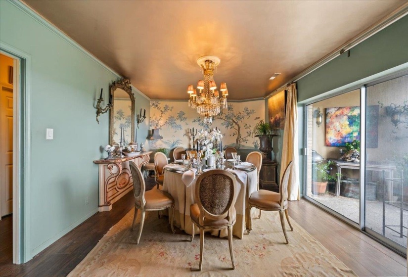 Dining room featuring a chandelier, wood finished floors, and ornamental molding