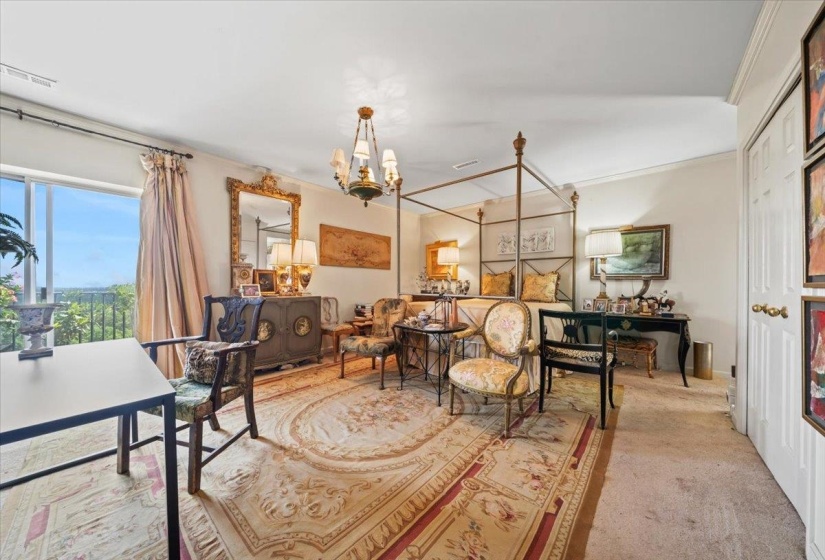 Carpeted office space featuring a chandelier and crown molding