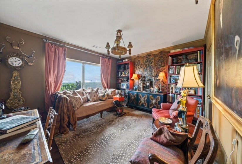 Living area featuring crown molding and a chandelier