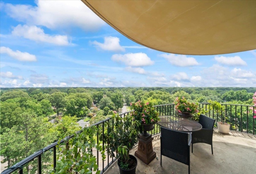 Balcony featuring a forest view