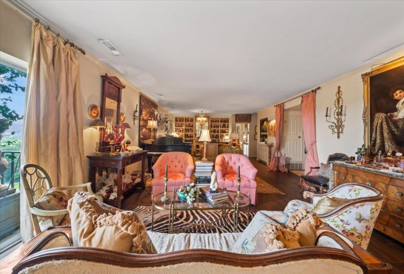 Living room featuring wood finished floors and crown molding