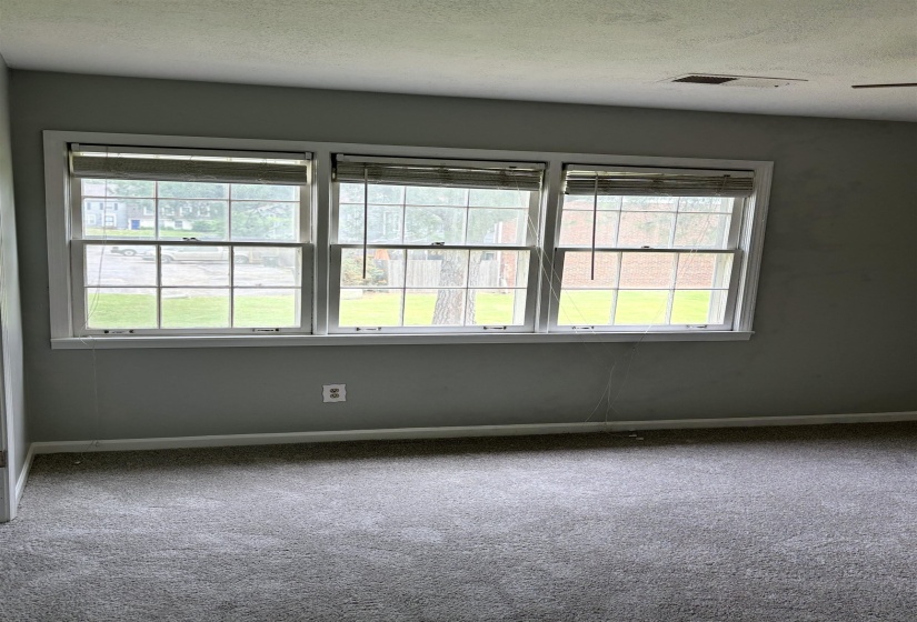 Wall-to-wall gray carpeting with light gray painted walls