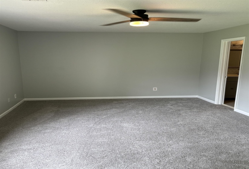 Neutral wall paint, new carpeting, ceiling fan with integrated lighting, and white baseboards