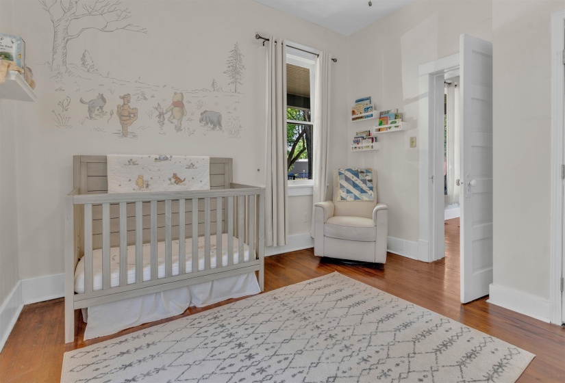 Hardwood flooring throughout featuring white trim and baseboards