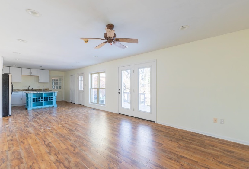 Unfurnished living room featuring light wood-style flooring, a ceiling fan, and recessed lighting