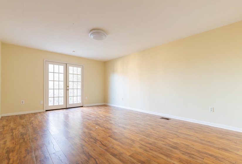 Unfurnished room featuring french doors and light wood-style floors