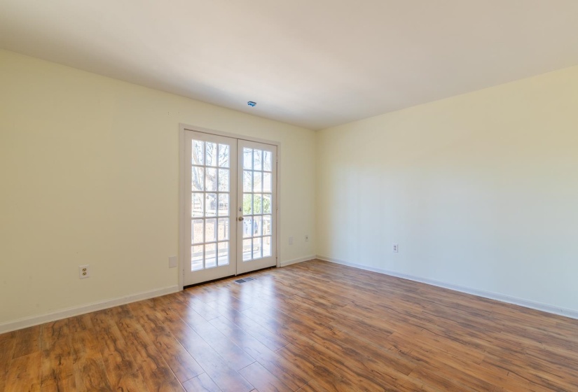 Unfurnished room with french doors and wood finished floors