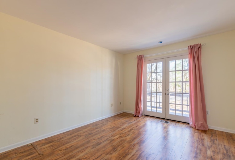 Empty room with french doors and wood-type flooring