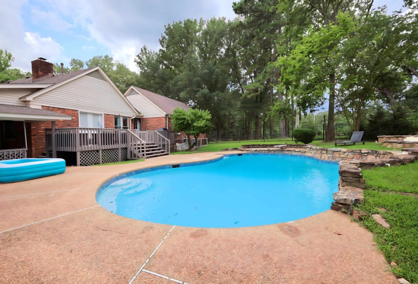 Swimming pool with a deck and a patio area