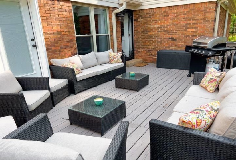 Wooden terrace featuring an outdoor living space and area for grilling