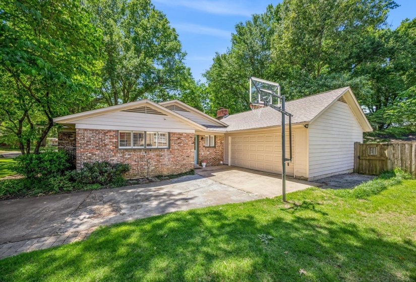 Brick exterior with integrated garage and concrete driveway