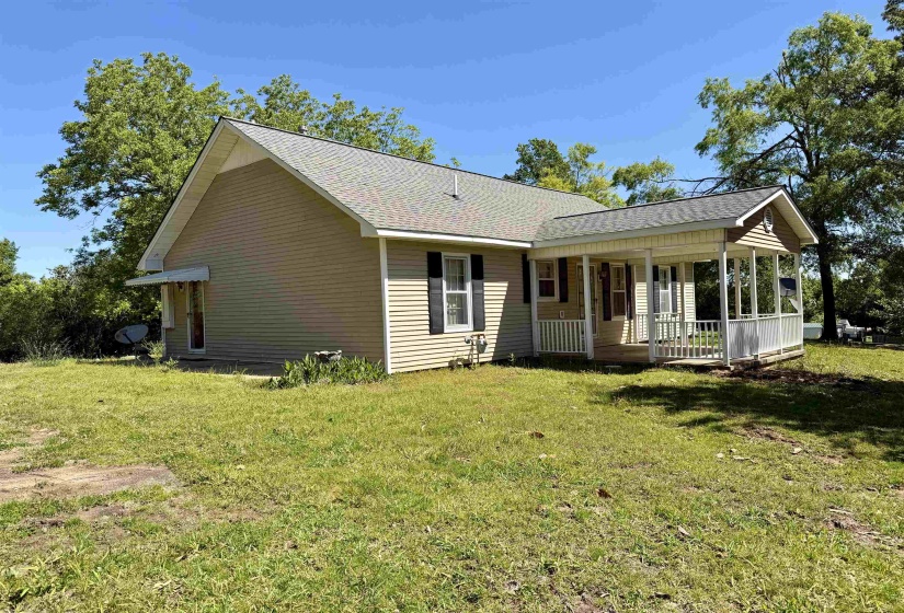 Single-story residence featuring light-colored siding and a covered front porch with white railing