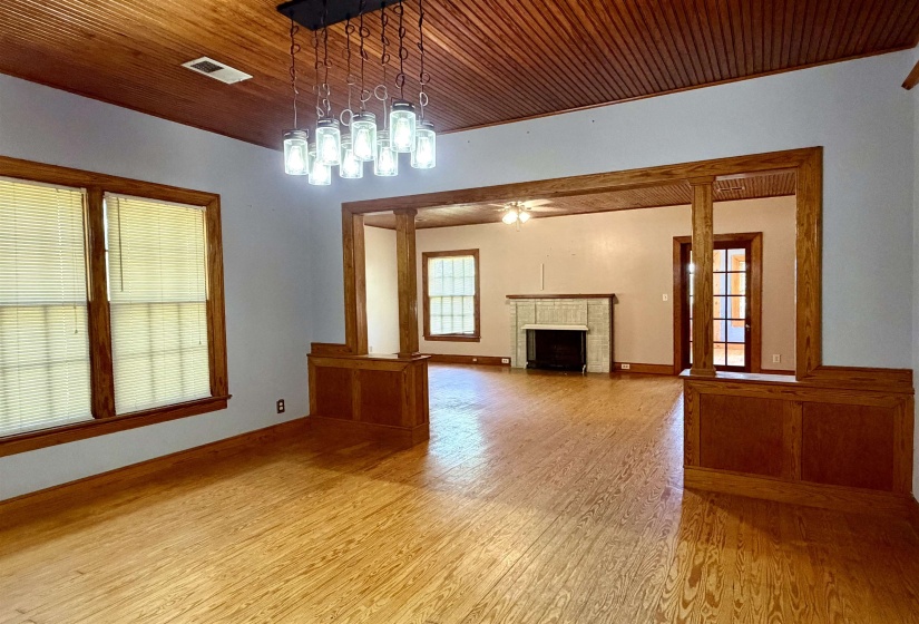 Spacious interior featuring wood-finish flooring, wood-paneled ceilings, and decorative wood trim throughout