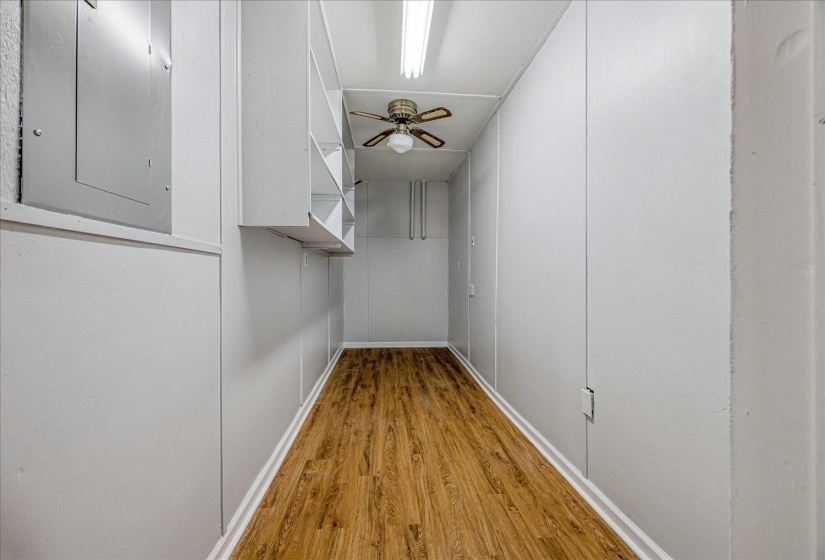 Hallway featuring light wood-type flooring and electric panel