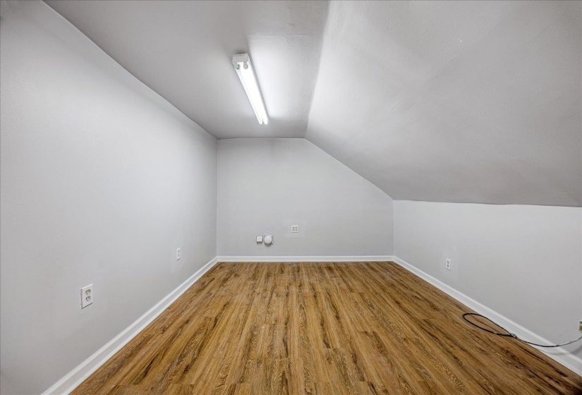 Bonus room with wood finished floors and lofted ceiling