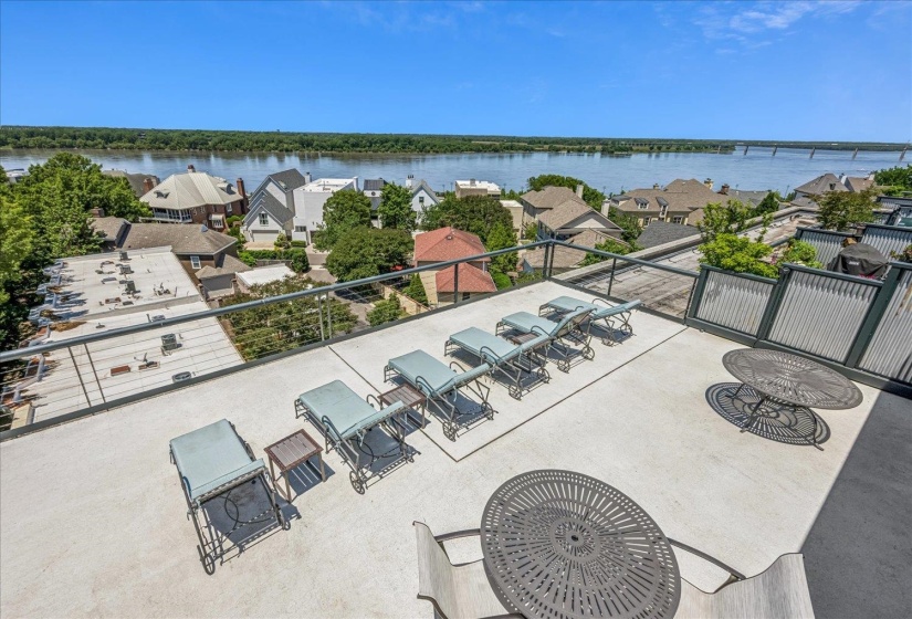 Expansive rooftop deck featuring a river backdrop and surrounding neighborhood architecture