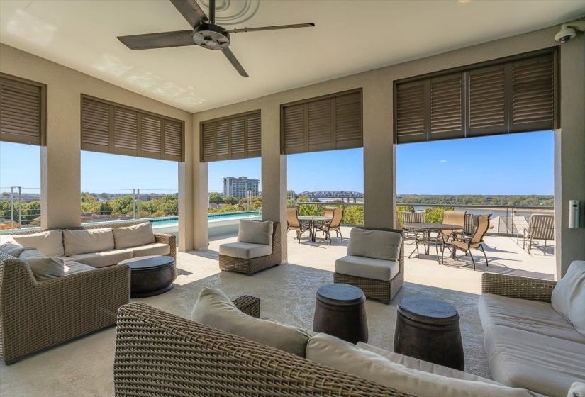 Covered outdoor patio with a ceiling fan, recessed lighting, and louvered window treatments