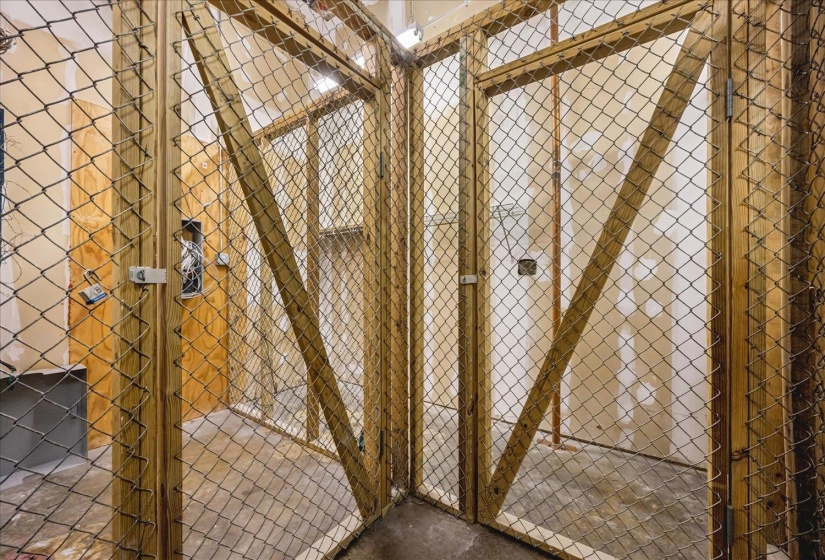 Chain-link storage cages with wood framing and concrete flooring