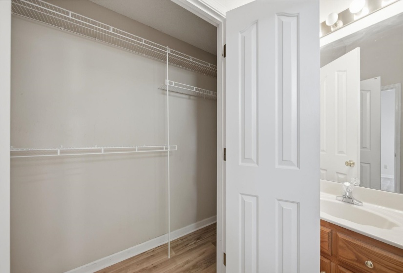 Spacious walk-in closet featuring wire shelving and hanging rods