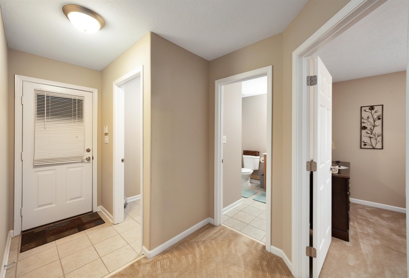 Entryway featuring a white door with integrated blinds, ceramic tile flooring, and a flush-mount ceiling light