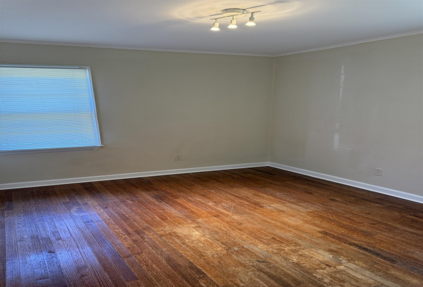 Hardwood-finish flooring throughout, complemented by a white baseboard trim