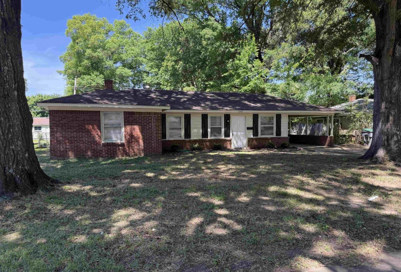 Ranch-style exterior with a brick and siding facade, covered entry, and attached carport