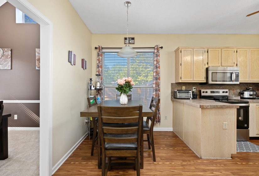Kitchen and dining area featuring wood-finish flooring