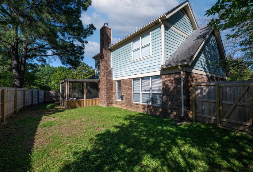 Private backyard featuring a screened porch and a full perimeter fence
