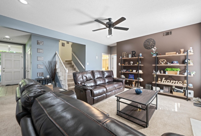 Open living space featuring carpet flooring and recessed lighting