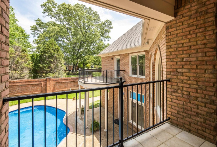 Balcony with tile flooring and black iron railings