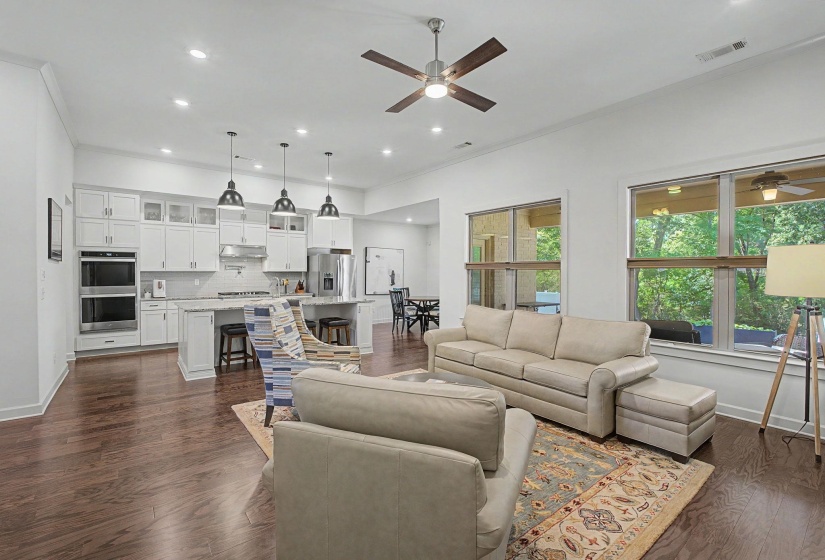Open-concept living area featuring wood-finish flooring, recessed lighting, and a ceiling fan