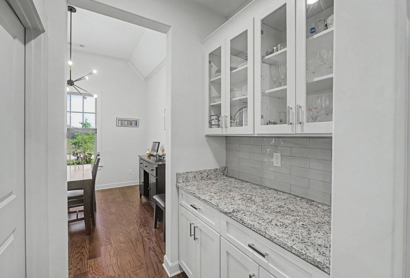 Built-in cabinetry with glass-front upper doors and lower storage drawers