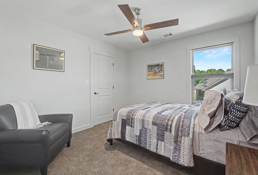 Room featuring a ceiling fan with wood-finish blades, a single window, and light gray wall paint