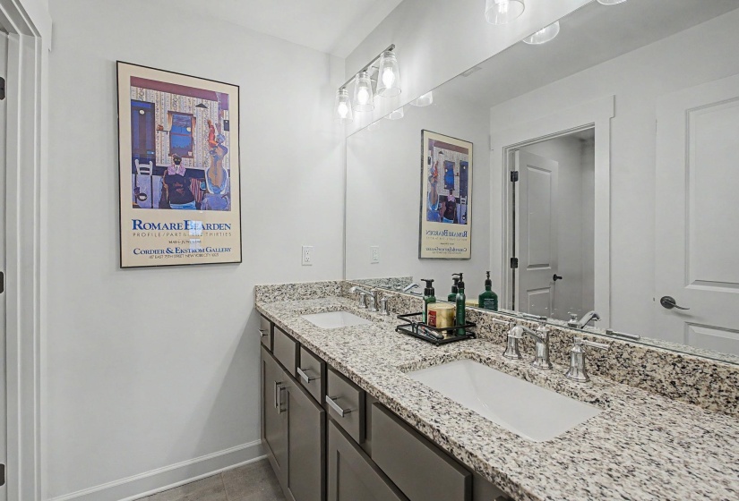 Double vanity with granite countertop, integrated rectangular sinks, and chrome faucets