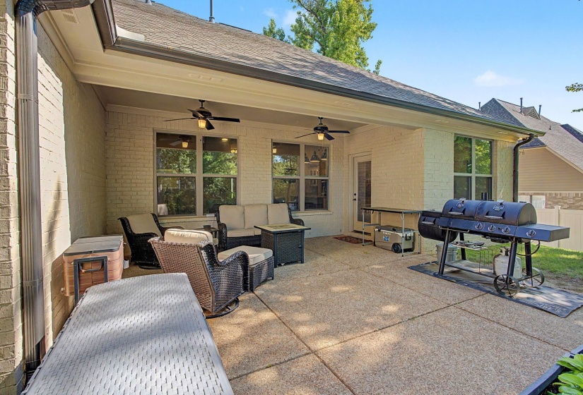 Expansive covered patio featuring a concrete surface and a painted brick exterior