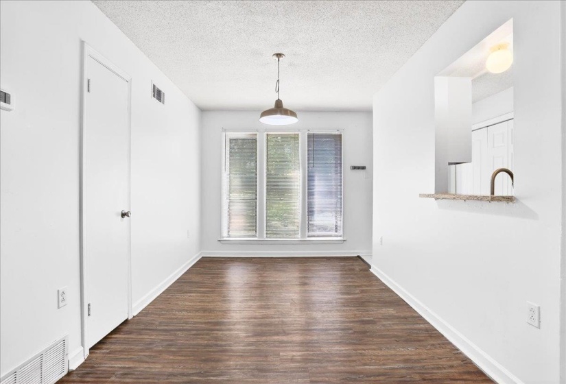 Room featuring wood-finish flooring, white walls, and a recessed ceiling